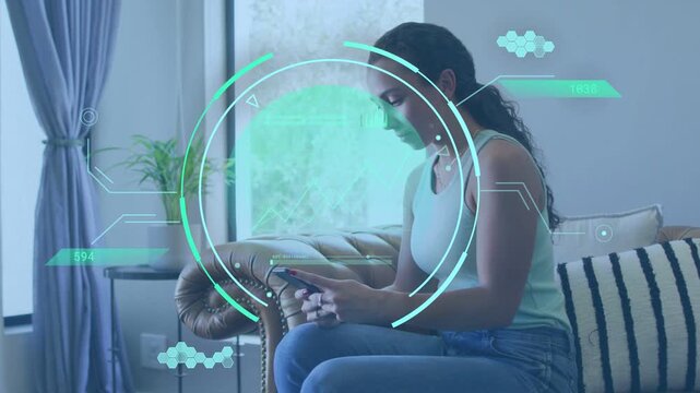 Woman tapping handheld device on sofa by window, HUD appearing and guiding technology app testing