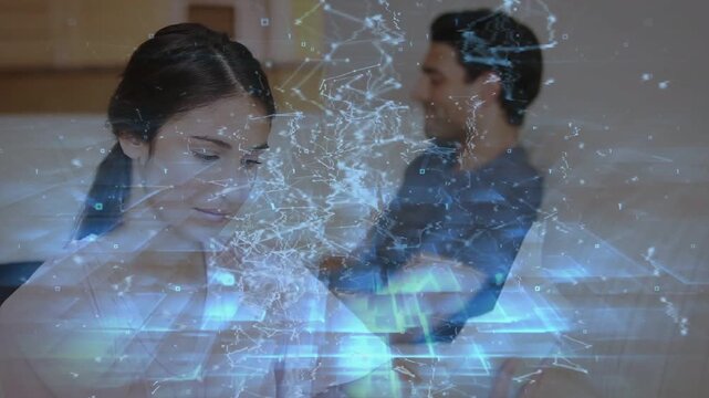 Woman checking tablet message smiling man watching tech overlay sweeping diagonally obscuring them