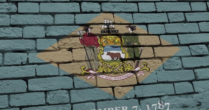 A panning video of a brick wall with the delaware state flag of the United States of America