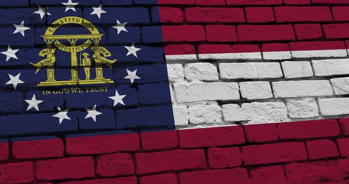 A panning video of a brick wall with the georgia state flag of the United States of America