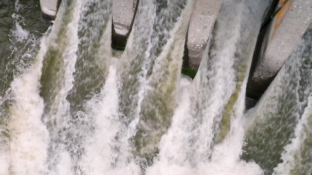 Slomo Top-Down view of Water Rushing through Dam in Southern Oregon - Drone