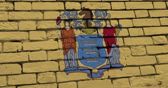 A panning video of a brick wall with the new jersey state flag of the United States of America