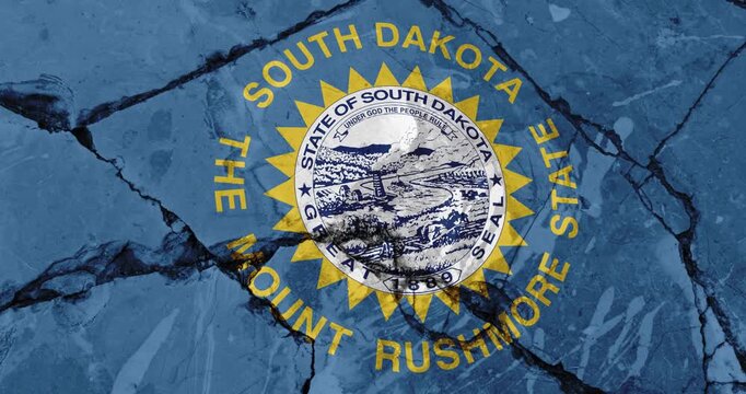 A panning video of a cracked wall with The south dakota state flag of the United States of America