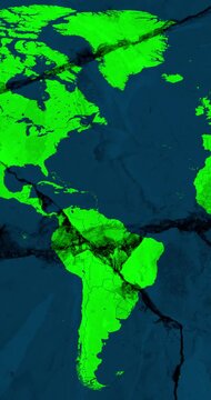 A panning vertical video with a green world political map over a blue cracked wall