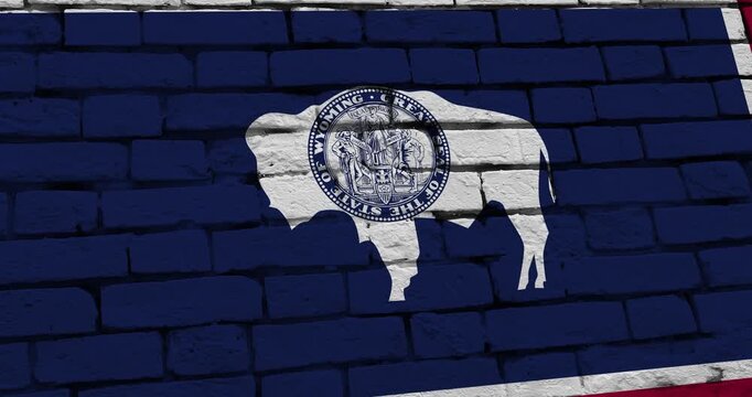 A panning video of a brick wall with the wyoming state flag of the United States of America