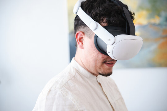 A man wearing a virtual reality headset experiences an immersive digital world, engaging with technology for entertainment or work.
