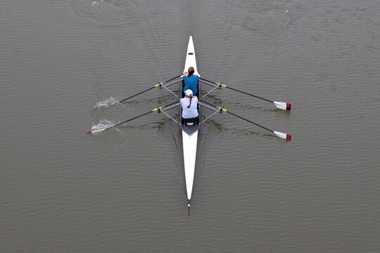 2 person sculling boat moving silently over the water