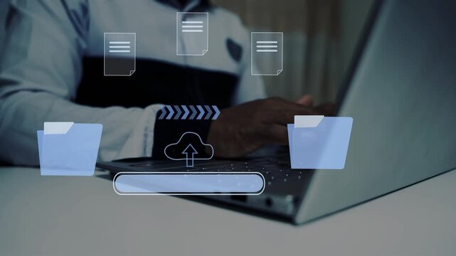 A business man working on a laptop computer with holographic files sharing icons folder animation