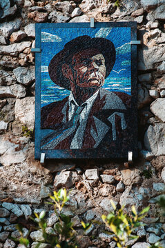 Mosaic Art of a Man Displayed on a Stone Wall in a Sunny Outdoor Setting in the Day Time