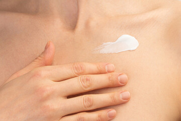 Naklejka premium Woman Applying Moisturizing Cream on Collarbone, Skincare and Body Care Concept