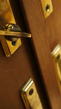 A Man Unlocks a Sliding Glass Door - Vertical