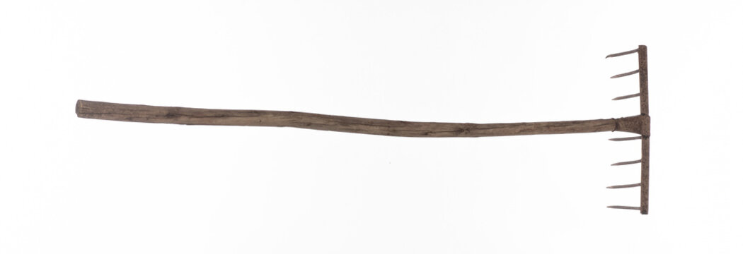 Old garden rake isolated on white background