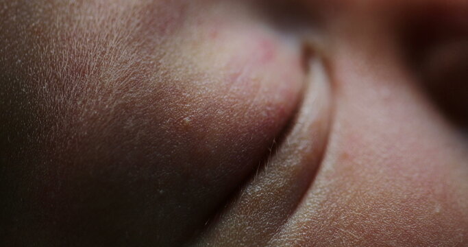Macro close up of newborn with eye closed sleeping
