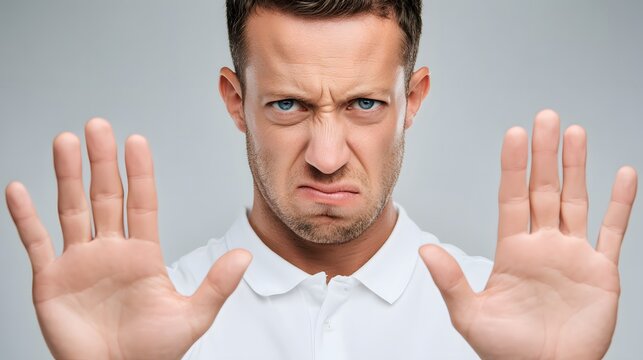 Man with intense expression holds both hands forward