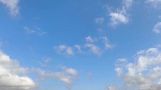 Orangeish clouds moving in the sky in the beggining of day