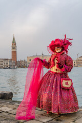 Naklejka premium Venice Carnival masks and costumes in Venice Italy. Colourful masquerade festival with ornate designs creates iconic cultural celebration.