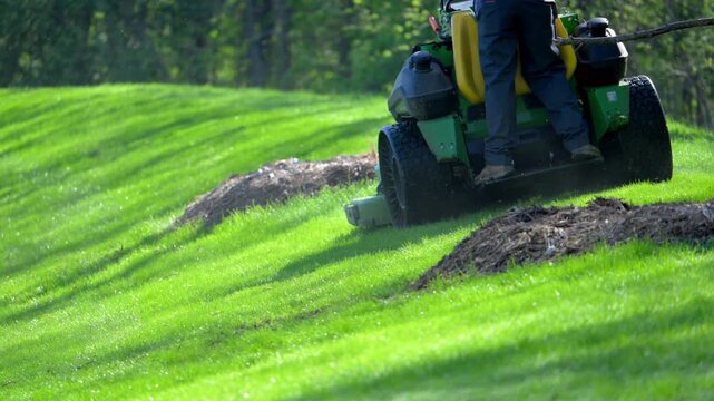 Slow motion of Professional grass cutting with a large lawn mower, landscaping service.