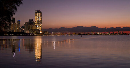 Naklejka premium Miami Skyline at Sunrise with Waterfront Reflections