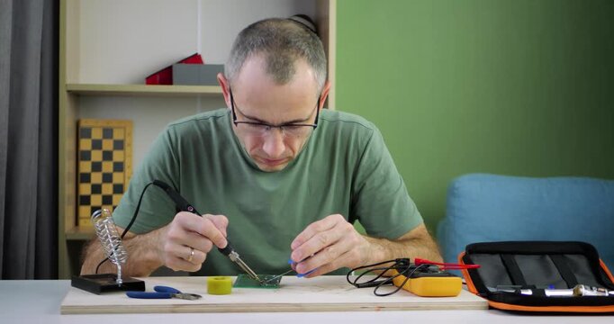 Engineer soldering electronic components on circuit board in modern workspace. Professional electronics assembly, innovation, and technology development concept. Work environment. technical expertise