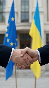 close up of official handshake of european union and ukraine representatives against state flags and building symbolizing international cooperation support partnership and unity