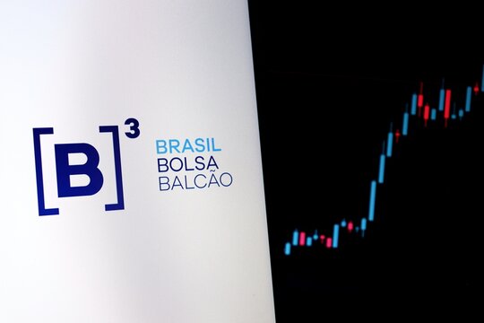 S&atilde;o Paulo, Brazil - April 29, 2026: B3 Brasil Bolsa Balc&atilde;o logo on a screen with a financial candlestick chart in the background. Brazilian B3 stock market trading. Ibovespa. 