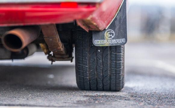 Gothenburg, Sweden - March 08 2026: Rear tire exhaust and Cougar mudflap detail on vintage American muscle car.