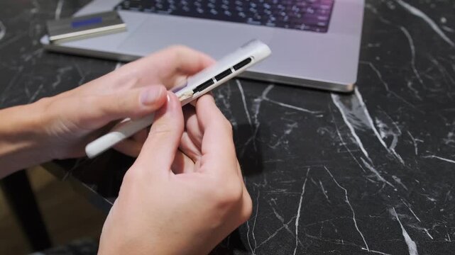 Close-up of removing memory card from a smartphone slot, showing mobile storage management, data transfer workflow and everyday handling of digital devices and removable media in modern technology use