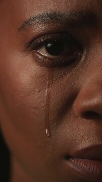 Sad, face and woman with depression, crying and mental health for trauma memories of emotional abuse. Closeup, tears and black person with anxiety, loneliness and despair for tragedy experience.