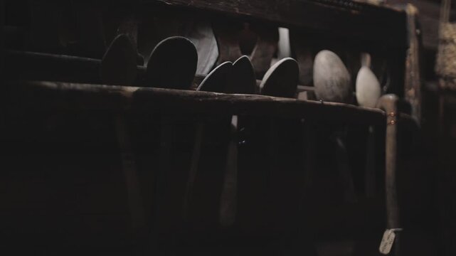 A collection of spoons suspended from a metal rack, great for use in food photography or as a decorative element