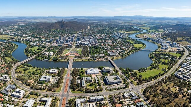 Aerial view of Canberra with prominent roads and the Molonglo River, expansive cityscape with urban planning, civic buildings and natural waterway, travel and geography concept from above, clear