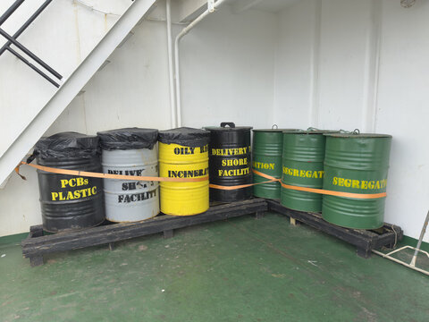 barrels for storage garbage wastes on board ocean going cargo ship. all separated by category and ready for incineration or discharging ashore. 