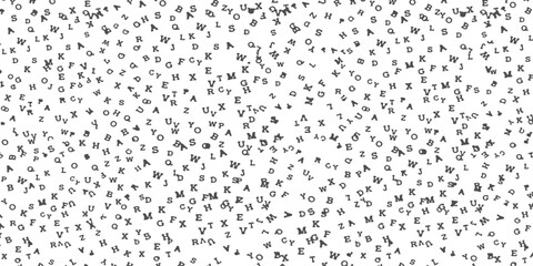 Black letters scattered randomly on a plain surface creating a textured alphabet pattern © Sharmin