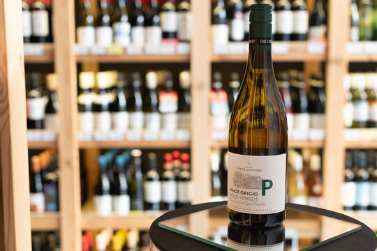 Bottle of Tenuta Corte Giacobbe Pinot Grigio delle Venezie DOC white wine on a mirror surface in a wine store with blurred shelves in the background. Ukraine, Zhytomyr, April 28, 2026