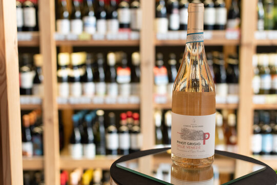 Bottle of Tenuta Corte Giacobbe Pinot Grigio delle Venezie DOC Ramato ros&eacute; wine on a mirror surface in a wine store with blurred shelves in background. Ukraine, Zhytomyr, April 28, 2026