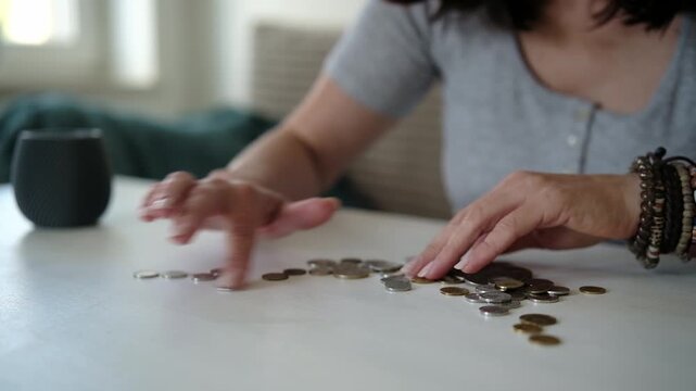 Girl Counts The Coins On A Table