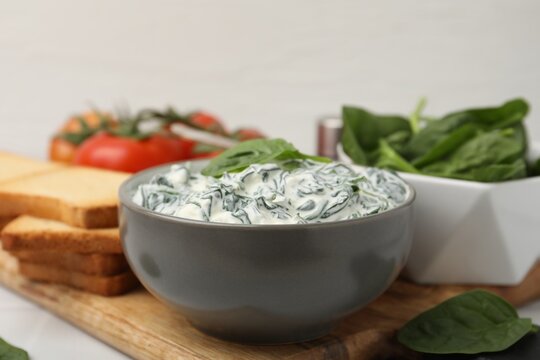 Delicious creamed spinach served on table, closeup