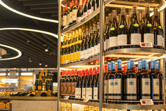Luxury champagne and wine display in modern airport duty-free shop, featuring Moet Chandon, Veuve Clicquot, with sleek lighting and premium branding, capturing travel retail elegance