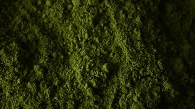 Matcha green tea powder rotating close up top view