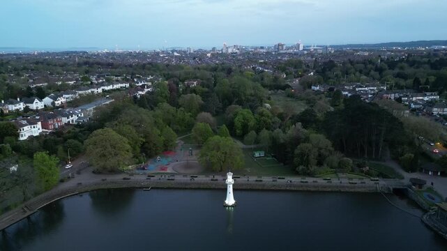 Cinematic 4K Drone Landing and Tracking Shot of Scott Memorial Lighthouse, Roath Park Lake