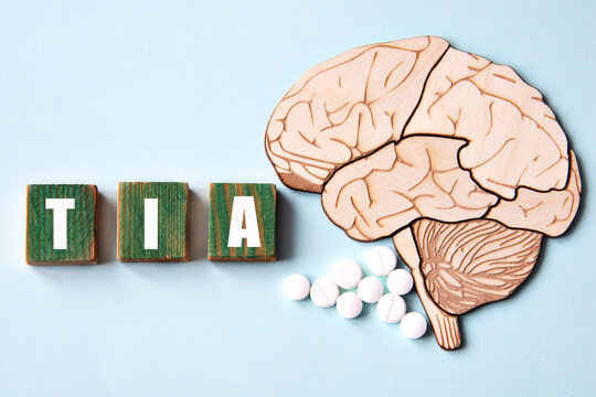 TIA is an acronym depicted on wooden cubes on a blue background with a skull brain model.