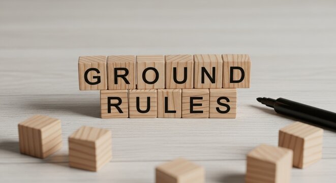 Wooden blocks spell "GROUND RULES" with scattered cubes and a marker nearby