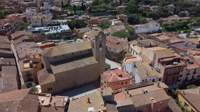 Aerial view of Sant Pere church and historic village rooftops in Begur, Spain.
