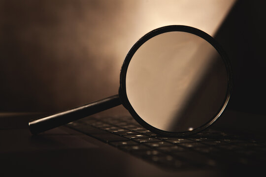 magnifier glass and computer keyboard