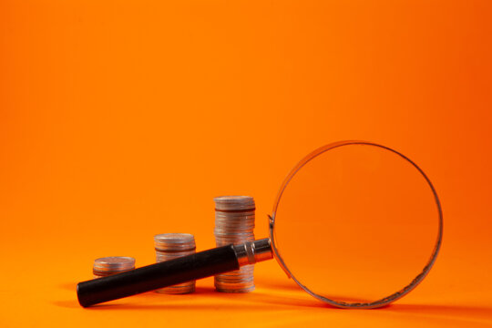 magnifying glass and coins ..