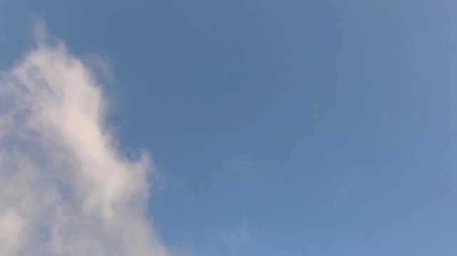Orange stratocumulus clouds moving in the sky early