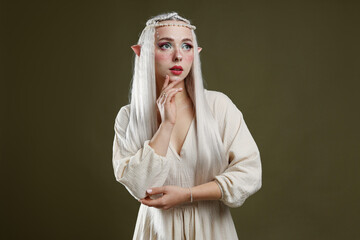Naklejka premium Beautiful elf girl on dark olive background