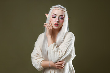 Naklejka premium Beautiful elf girl on dark olive background