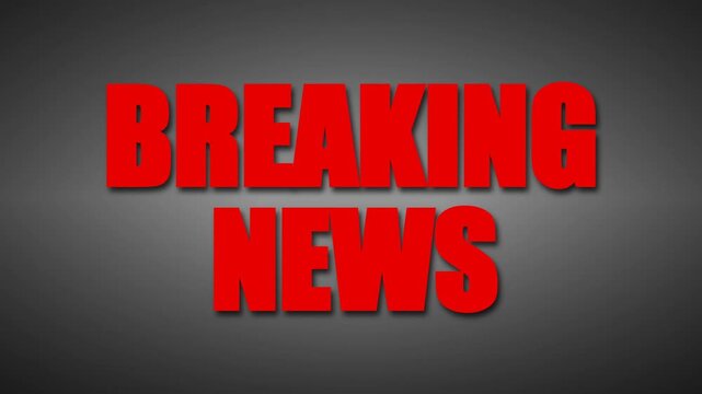 Breaking news text in red bold font flashing on a dark textured background for television broadcast.