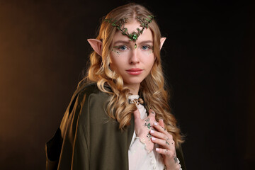 Naklejka premium Beautiful elf girl on black background with smoke