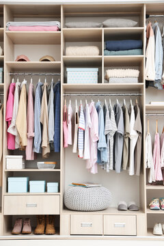 Large wardrobe with different stylish clothes and home stuff